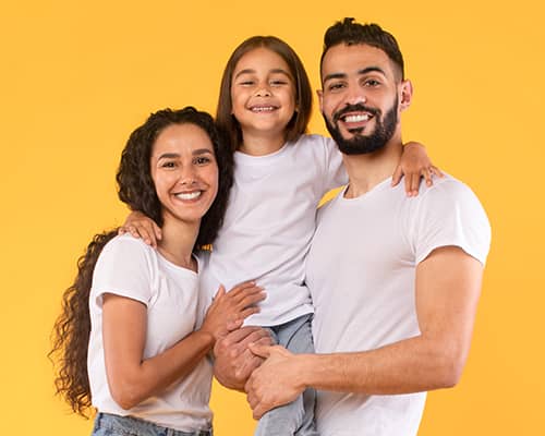 Happy parents hugging their daughter after qualifying for homebuyer assistance in Texas